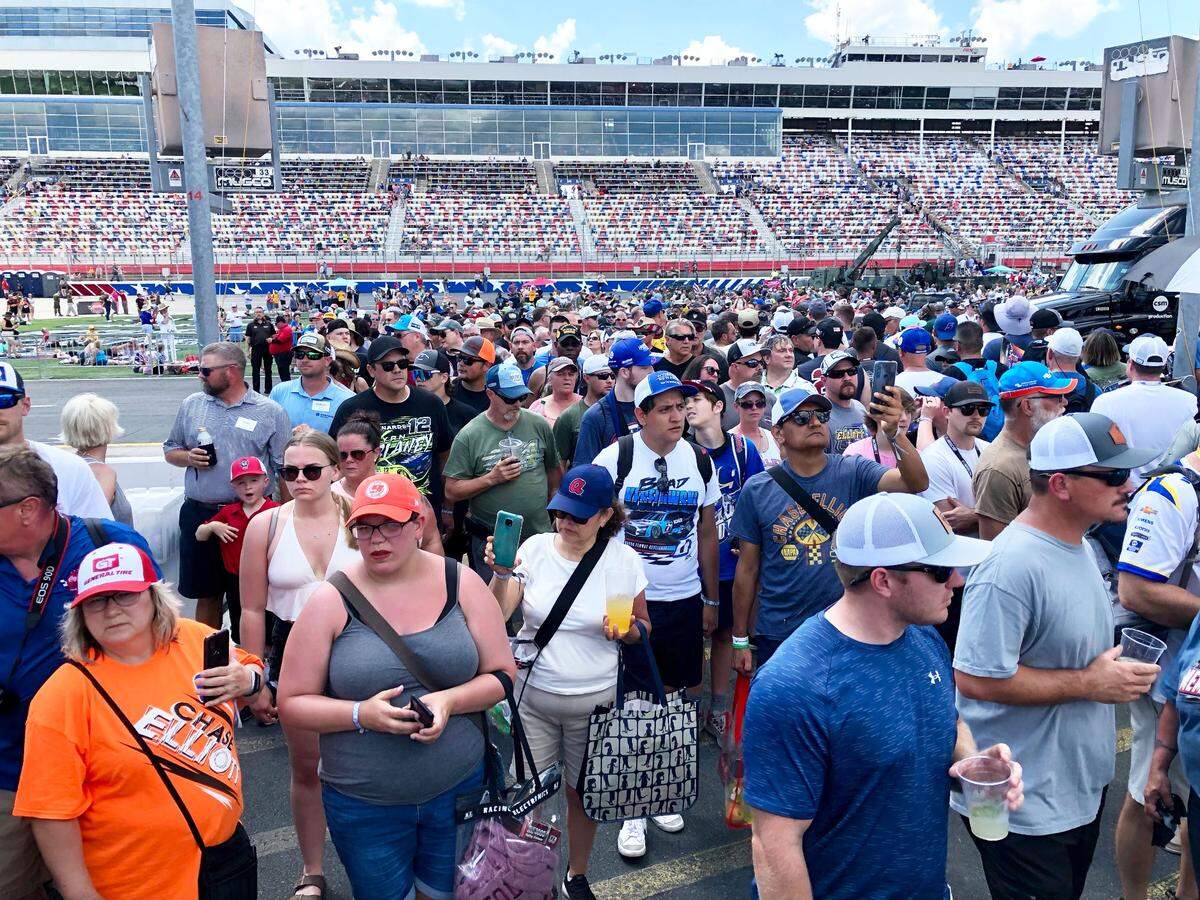 NASCAR fans mingle around pit road and behind the pit boxes at the Coca-Cola 600 on Sunday, May 29, 2022 at Charlotte Motor Speedway.
