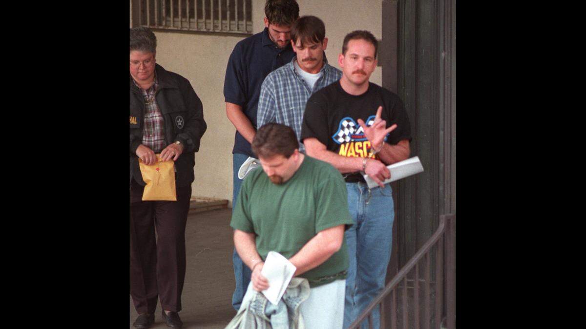 Deputy U.S. marshals lead Loomis Fargo robbery suspects, from front, Steve Chambers, Eric Payne, Thomas Grant and Michael McKinney through the back doors of the federal courthouse in Charlotte on March 3, 1998.