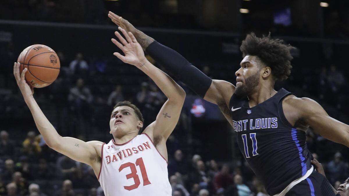 Davidson’s Kellan Grady (31) drives past Saint Louis’ Hasahn French (11) during the first half of an NCAA college basketball game in the semifinal round of the Atlantic 10 men’s tournament Saturday, March 16, 2019, in New York. (AP Photo/Frank Franklin II)