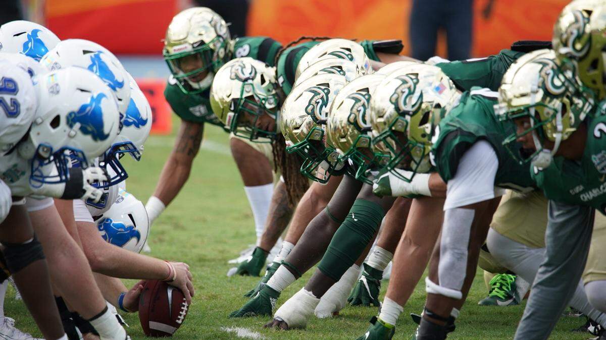 The Charlotte 49ers’ defense, right, lined up against Buffalo during the Bahamas Bowl on Friday. It was Charlotte’s first bowl game and the 49ers completed their first winning season (7-6).