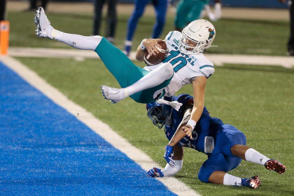 Coastal Carolina quarterback Grayson McCall flips over Kansas linebacker Dru Prox to score a touchdown in the first half of an NCAA college football game in Lawrence, Kan., Saturday, Sept. 12, 2020.