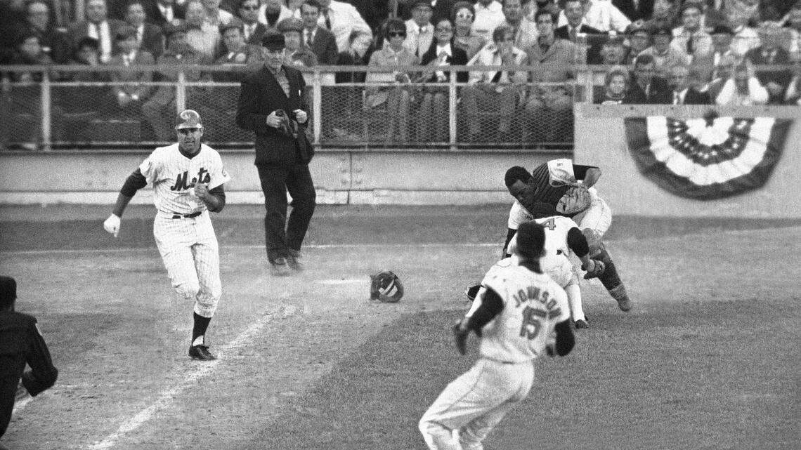 Orioles catcher Ellie Hendricks and pitcher Pete Richert reach for bunt laid down by J.C. Martin in 10th inning of fourth World Series game in New York Oct. 15, 1969. Richert fielded it and his throw to Dave Johnson hit Martin in back and bounded away, enabling Rod Gaspar to score from second. Umpire is Shag Crawford. Martin now lives near Charlotte. (AP Photo)