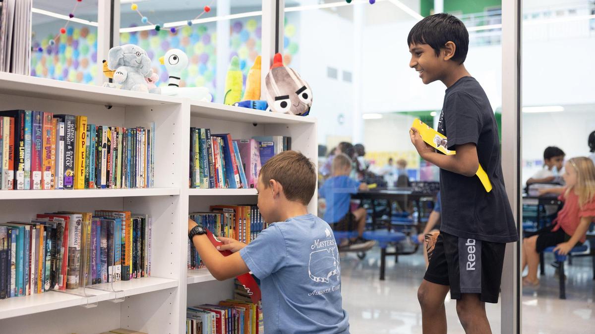 Fourth grade students check out books at Lake Norman Charter Elementary School in Huntersville, N.C., on Thursday, September 8, 2022.