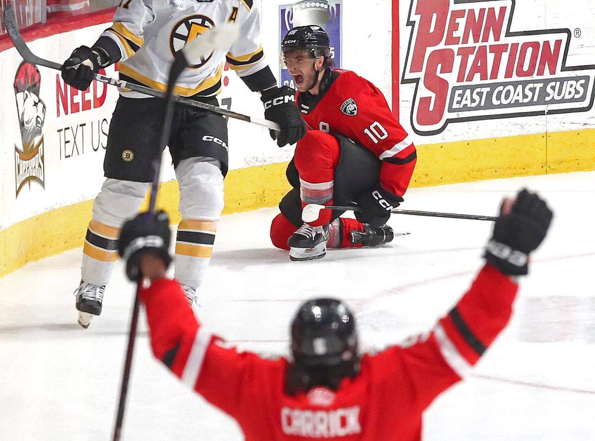 Charlotte Checkers forward Will Lockwood, top/center, celebrates his goal against the Providence Bruins on Wednesday, May 7, 2025. The Providence Bruins defeated the Charlotte 3-2.