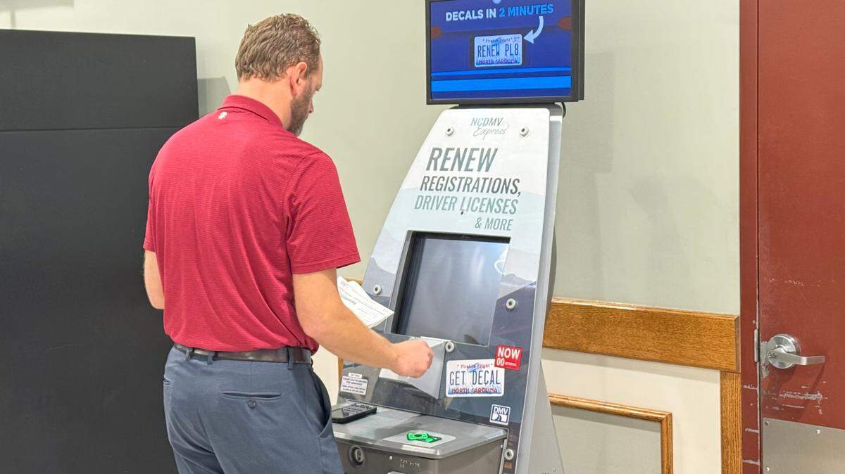 NCDMV’s communications manager Marty Homan demonstrates how to complete a vehicle registration renewal transaction at a kiosk in a Charlotte Harris Teeter on Monday, Aug. 26, 2024.