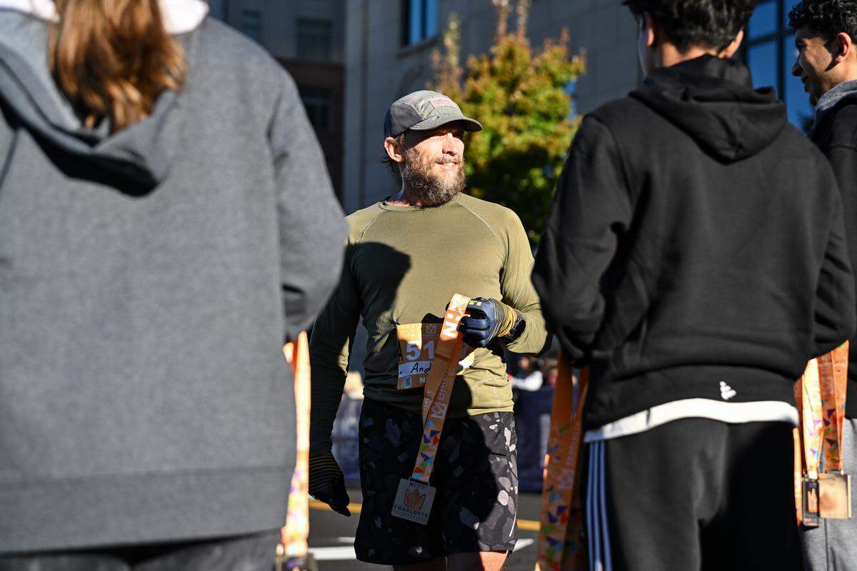 A participant receives their medal after taking part in the 20th annual Novant Health Charlotte Marathon on Saturday, Nov. 16, 2024, in Charlotte