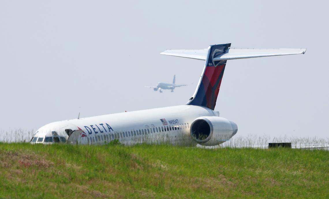A Delta Airlines plane sits on a runway at Charlotte Douglas International Airport in Charlotte, NC on Wednesday, June 28, 2023 after it landed without landing gear. Delta Flight 1092, a Boeing 717 landed with 101 people onboard. The flight arrived in Charlotte from Atlanta, GA. The plane remains on the runway due to mechanical issues according to the airport.