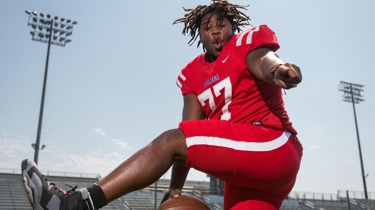 Olympic High School Trojans’ Football No. 77 center, 17-year old Jeremiah Burch Jr., poses for portraits at the Olympic High football field as the Charlotte Observer boy’s athlete of the year Wednesday June 15, 2022 in Charlotte, North Carolina. “I’ve been playing football since I was 5 years old,” Burch says. “All of my uncles played it, my dad played it, and my grandpa played it, so I grew up around football my whole life,” he said. In 2021, Burch had the opportunity to play in the Shrine Bowl and won several awards for football and several more as a track and field athlete throwing shot-put and discus.