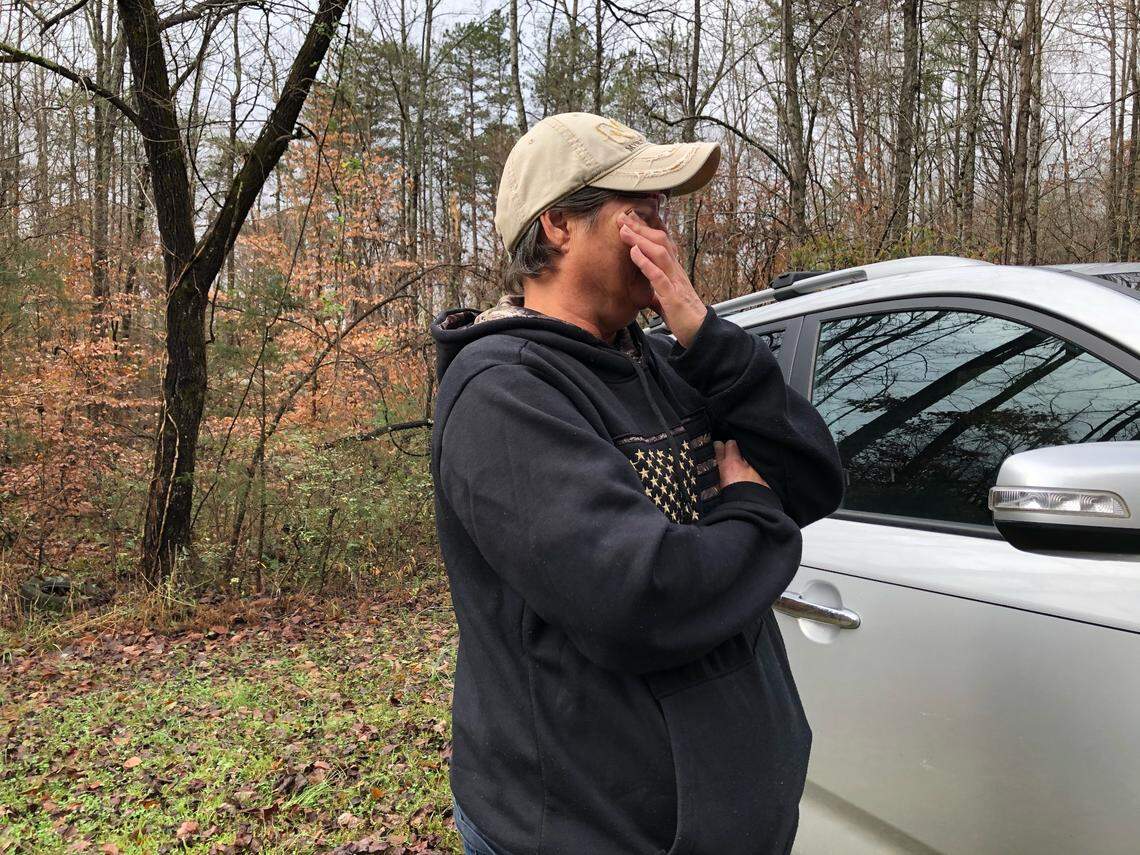 Lisa McHargue, of Love Valley, NC wipes away tears as she talks about the three people who died and the two who are missing from a campground that flooded in Alexander County, NC on Thursday, November 12, 2020.