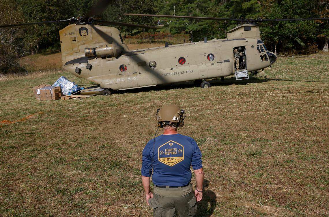 Jeffrey Schweitzer stands near the landing point for the Chinook helicopter piloted by Bravo Company 1-171 in Poplar, N.C., on Thursday, Oct. 3, 2024. Schweitzer is employed by Amazon and is a global lead with the company’s disaster response operations. Bravo Company 1-171 flew pallets of bottled water and ready to eat meals to the community in Western North Carolina that is suffering the effects of Hurricane Helene.