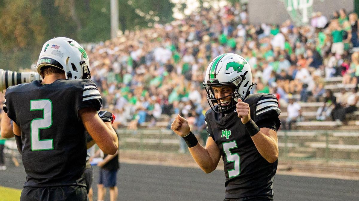 Myers Park Wendell Thompason, right, celebrates with Brody Keefe after he caught a touchdown pass in the first quarter against Ardrey Kell at Myers Park High in Charlotte on Friday, October 6, 2023.