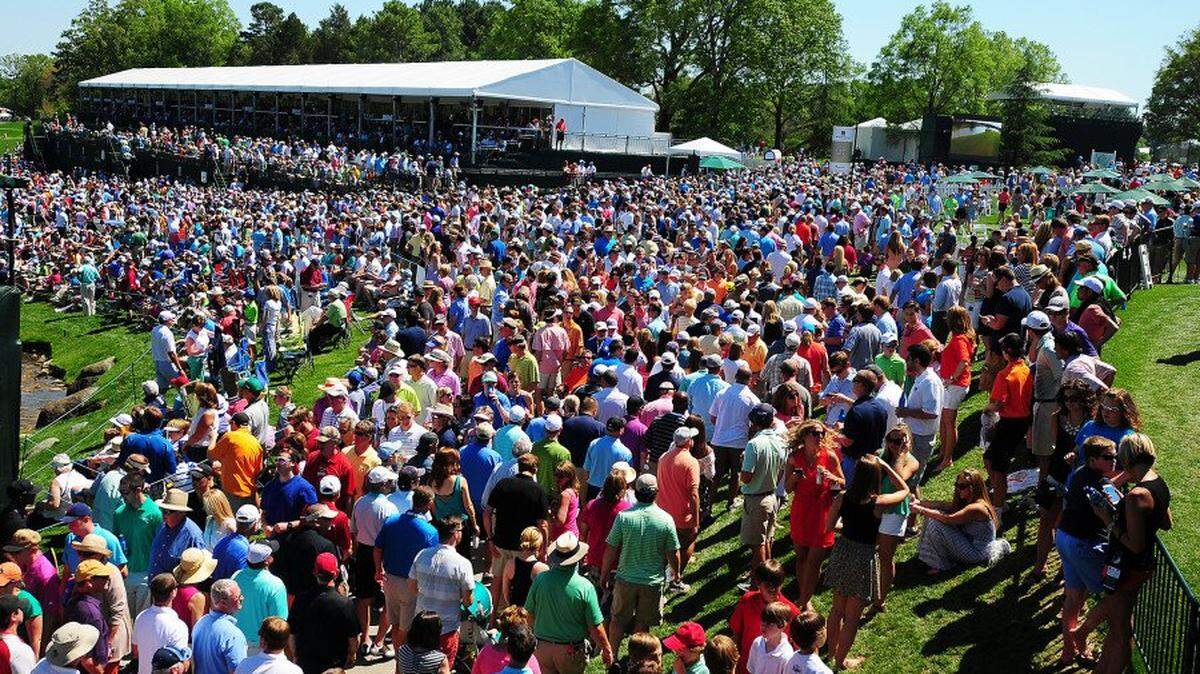 Fans crowd around the 18th green during the Wells Fargo Championship at Quail Hollow Club.