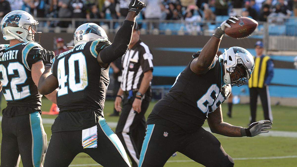 Carolina Panthers tackle Dennis Daley, right, spikes the football that running back Christian McCaffrey used to score a touchdown against Tennessee on Nov. 3rd during Carolina’s 30-20 win.