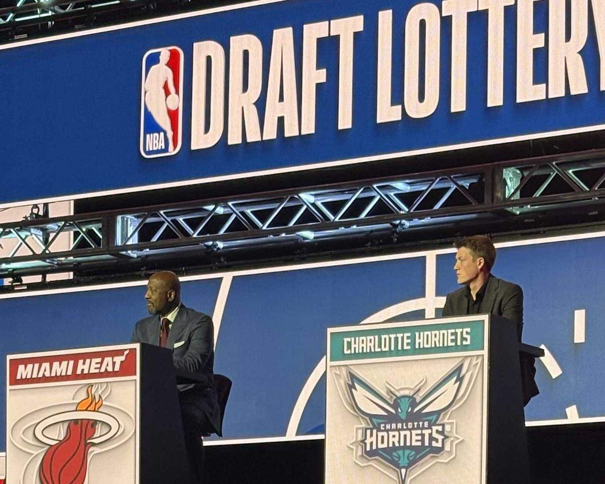 The Charlotte Hornets’ Kon Knueppel, right, sits on the dais at the NBA Draft Lottery event in Chicago on Sunday, May 10, 2026, next to the Miami Heat’s Alonzo Mourning.