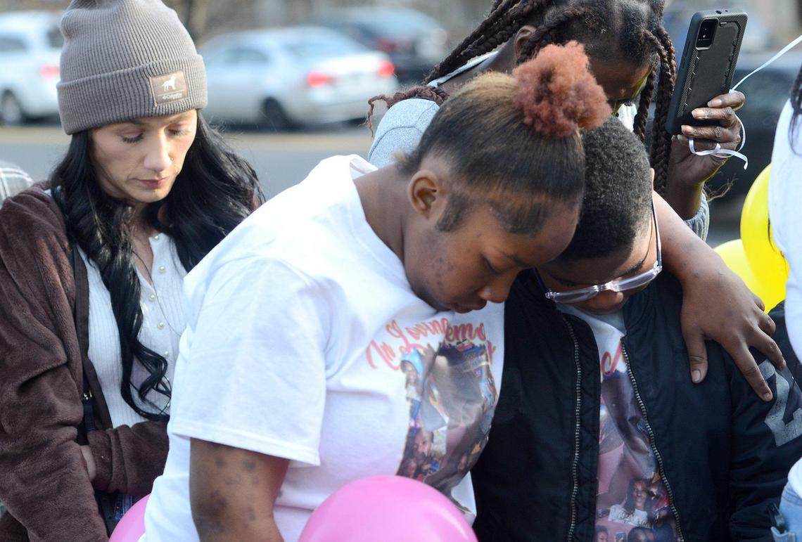 Rosheida Bennett, 20, draped her arm around 11-year-old Kaden Crawford, Ta’Haley Payton’s brother, during a brief prayer.