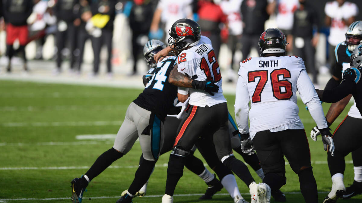 Carolina Panthers outside linebacker Shaq Thompson (54) tries unsuccessfully to sack Tampa Bay Buccaneers quarterback Tom Brady (12) in 2020. Brady and the Bucs beat Carolina twice last season.
