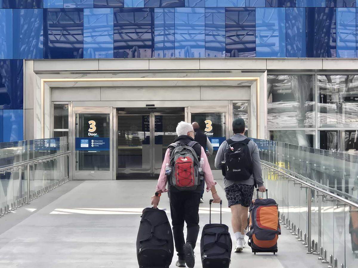 Passengers make their way toward the terminal at Charlotte Douglas International Airport amid the government shutdown, which is delaying flights across the country.