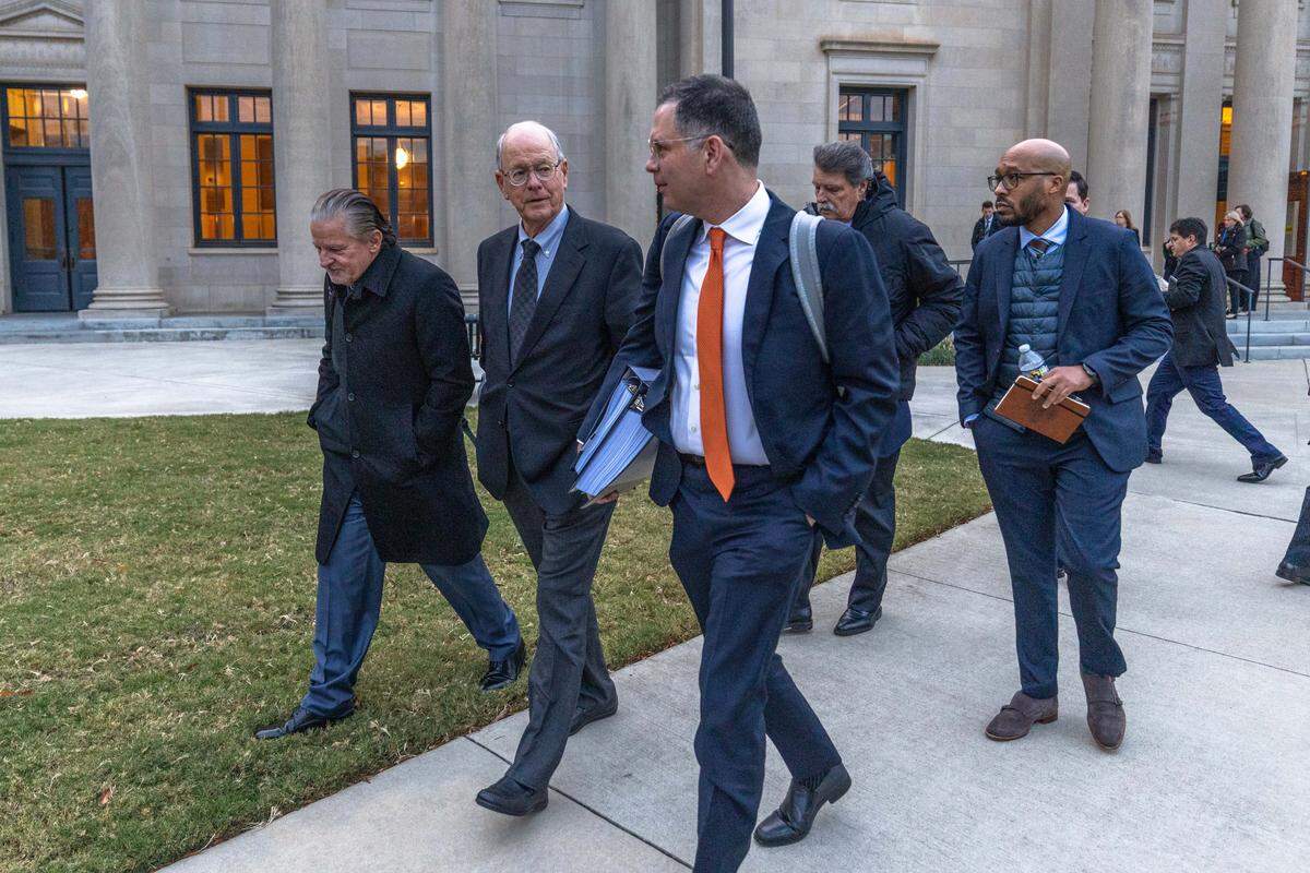 Jim France, center, NASCAR chairman and CEO, departs the Charles R. Jonas Federal Building on Dec. 1, 2025 in Charlotte. NASCAR reached a settlement Thursday with 23XI Racing and Front Row Motorsports in the antitrust lawsuit case.