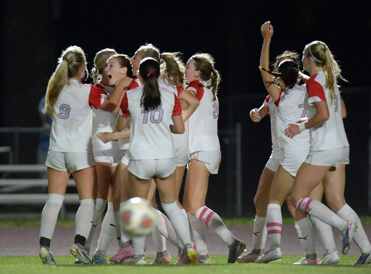 Charlotte Catholic's #15, Marguerite McPhillps (second from left), rejoices with her teammates after scoring a lated second half goal to break a 2-2 tie and win the game for the Cougars. The Charlotte Catholic Cougars girls soccer squad traveled to Marvin Ridge High School Mavericks for an evening match up between two teams ranked in the top ten nationally on Friday, April 17th, 2026.
