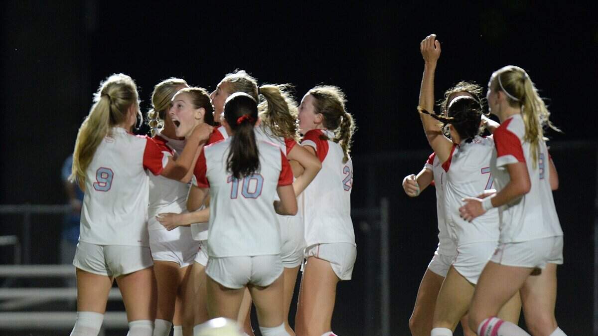 Charlotte Catholic's #15, Marguerite McPhillps (second from left), rejoices with her teammates after scoring a lated second half goal to break a 2-2 tie and win the game for the Cougars. The Charlotte Catholic Cougars girls soccer squad traveled to Marvin Ridge High School Mavericks for an evening match up between two teams ranked in the top ten nationally on Friday, April 17th, 2026.