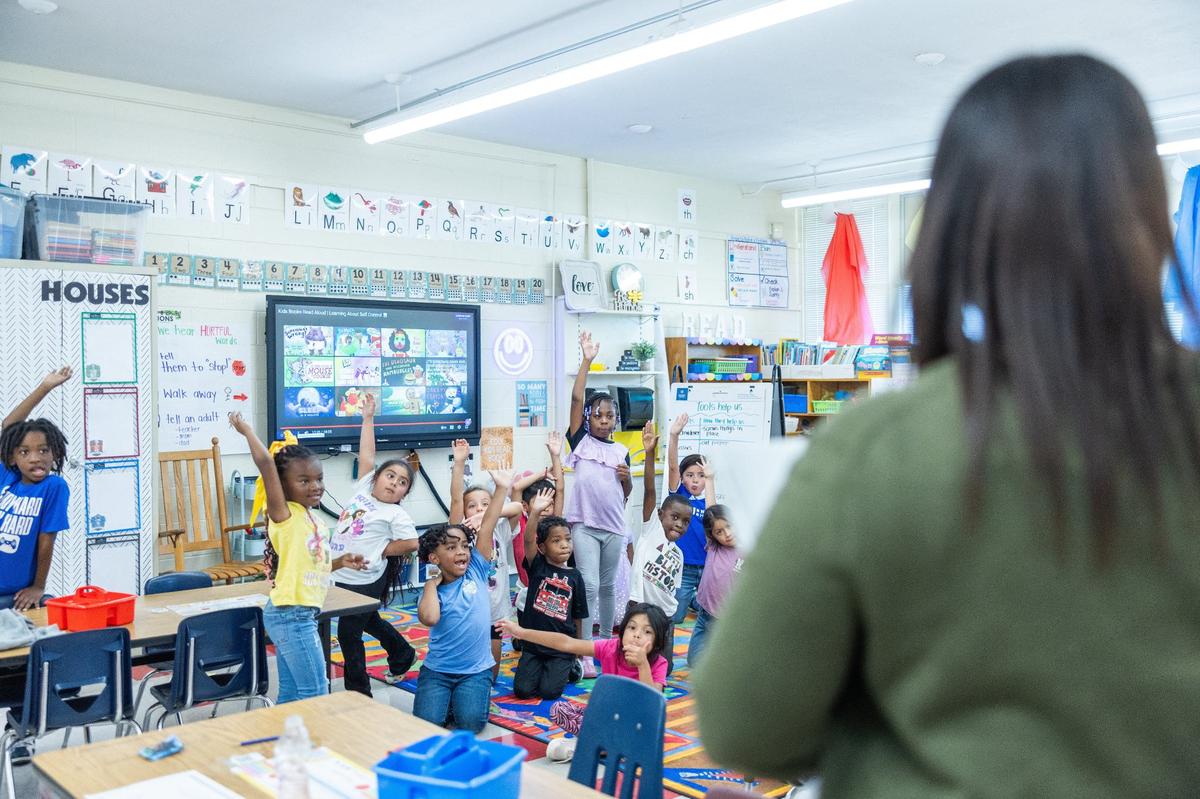 Principal Danielle Belton greets students and hands our smarties Paw Creek Elementary in Charlotte, N.C., on Wednesday, September 11, 2024.