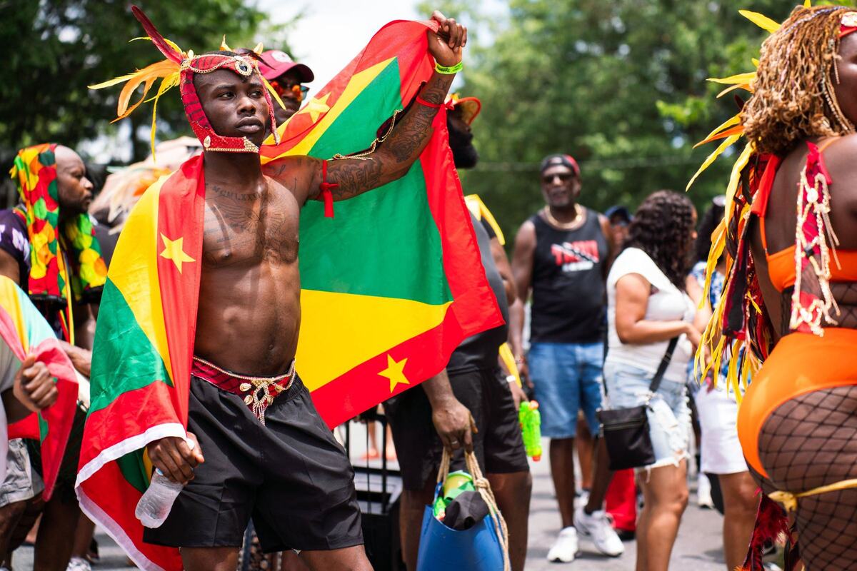 Nate Strother, 22, of Charlotte, was a masquerader in the Charlotte Caribbean Carnival parade on June 29. Strother, the first in his family born in the U.S., was representing Grenada.