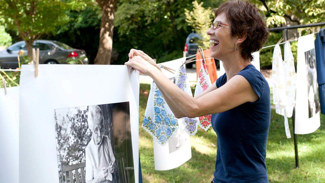 Yard Art Day founder Deborah Triplett joins in on an exhibit.