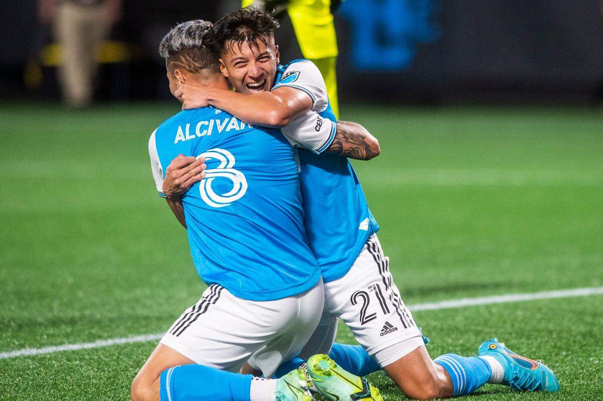 Charlotte FC forward Alan Franco, right, embraces defender Jordy Alcivar after Alcivar assisted in a goal during the game against the New England Revolution at Bank of America Stadium on Saturday, March 19, 2022 in Charlotte, NC. Charlotte FC defeated the Revolution, 3-1, for their first win of the season.