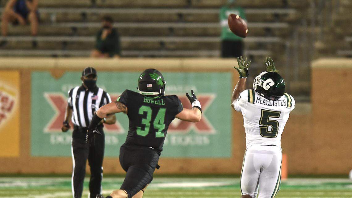 Charlotte running back Aaron McAllister (5) hauls in a 71-yard touchdown pass over North Texas’ Kyleb Howell (34) in the first half of the 49ers’ victory Saturday.