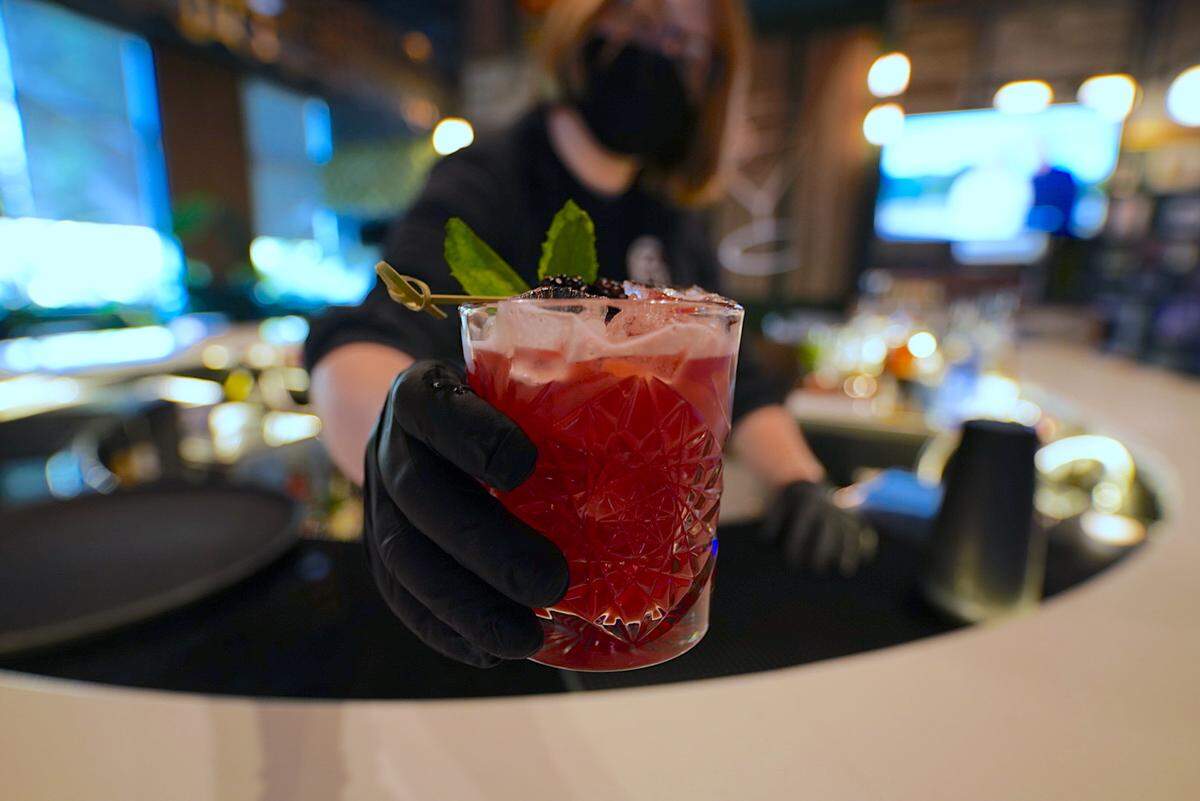 Inside The Leather, a cocktail at Stroke, is made of Bulleit Bourbon, housemade blackberry lemon syrup, muddled fresh mint.