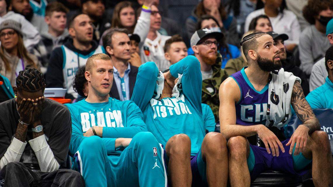 Players on the Hornets bench bury their faces in their hands during the game against the Pistons at Spectrum Center on Sunday, February 27, 2022 in Charlotte, NC. The Pistons defeated the Hornets 126-125 in overtime.