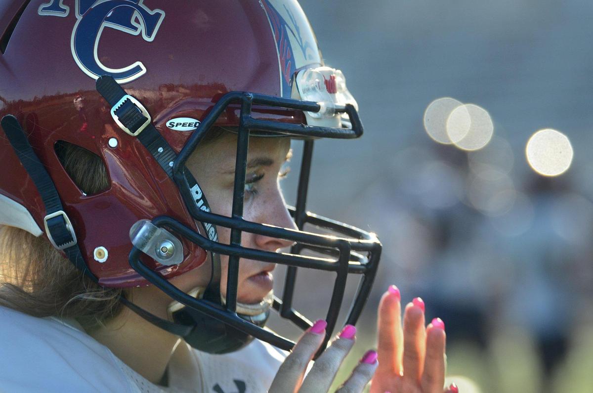 Charlotte Stavis, 17, is a girls soccer center midfielder at Mallard Creek High School who also starts as a kicker on the football team. Her pink fingernails match her pink kicking shoes. The senior is playing her second season on the football team.