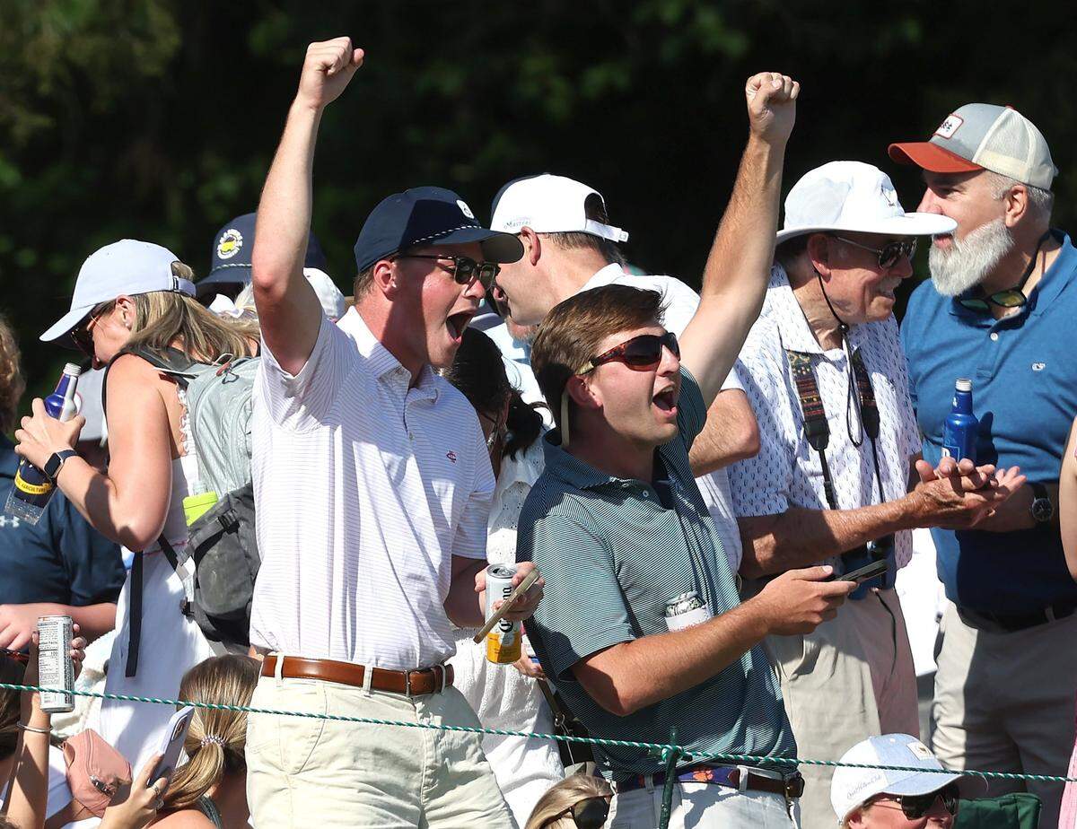 Fans cheer on Rory McIlroy after he chipped his ball into the cup from a sand trap at the 15th green during the final round of the Wells Fargo Championship at Quail Hollow Club in Charlotte, NC on Sunday, May 12, 2024. McIlroy sank the chip to eagle the hole. McIlroy won the Wells Fargo Championship at -17.