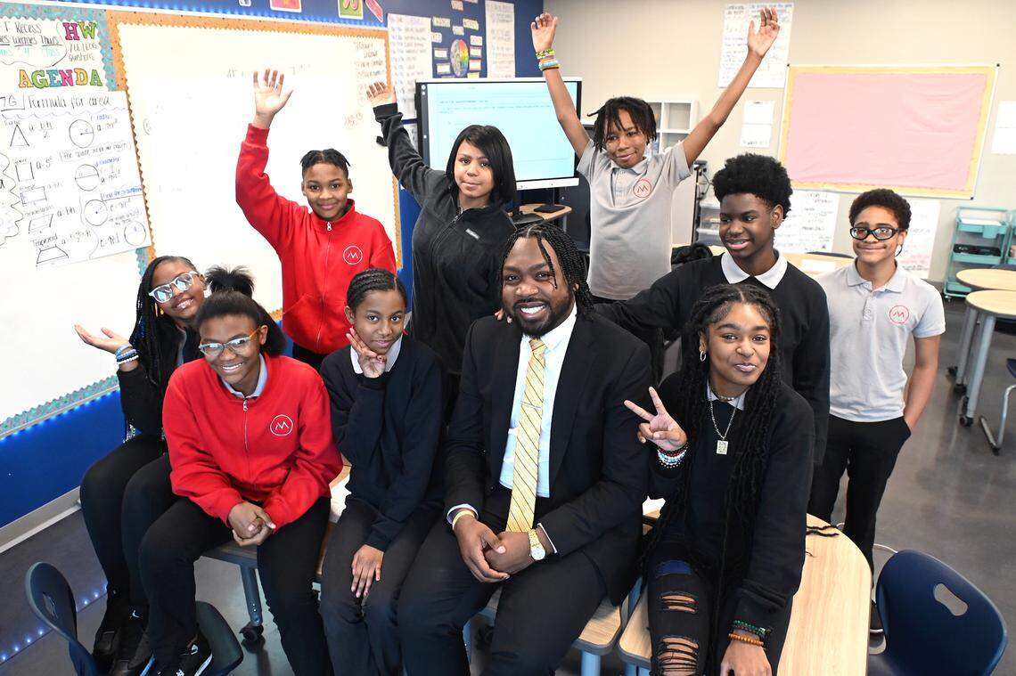 Kenneth Gorham, center, poses with fifth and sixth grade students on Tuesday, January 10, 2023. Gorham is the principal of Movement Freedom Middle School in Charlotte, NC. Gorham is only 25 years old and is the youngest principal in the charter school’s history.