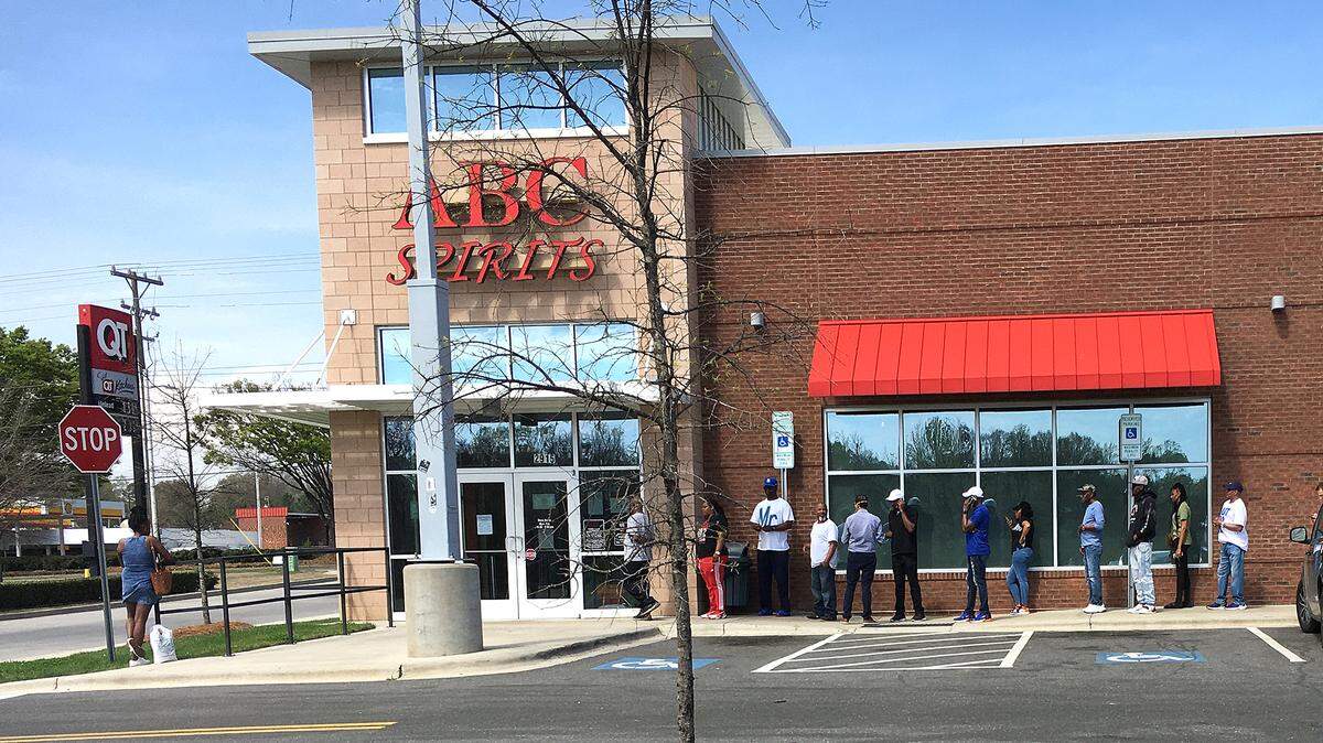 As clerks inside ABC Store #5 filled their orders and took their payments customers lined up outside at 2915 Wilkinson Blvd. on March 20. Mecklenburg County ABC Commission, said starting April 7, 10 liquor stores will open one hour early for seniors 65 and older to shop. John H. Simmons jsimmons@charlotteobserver.com