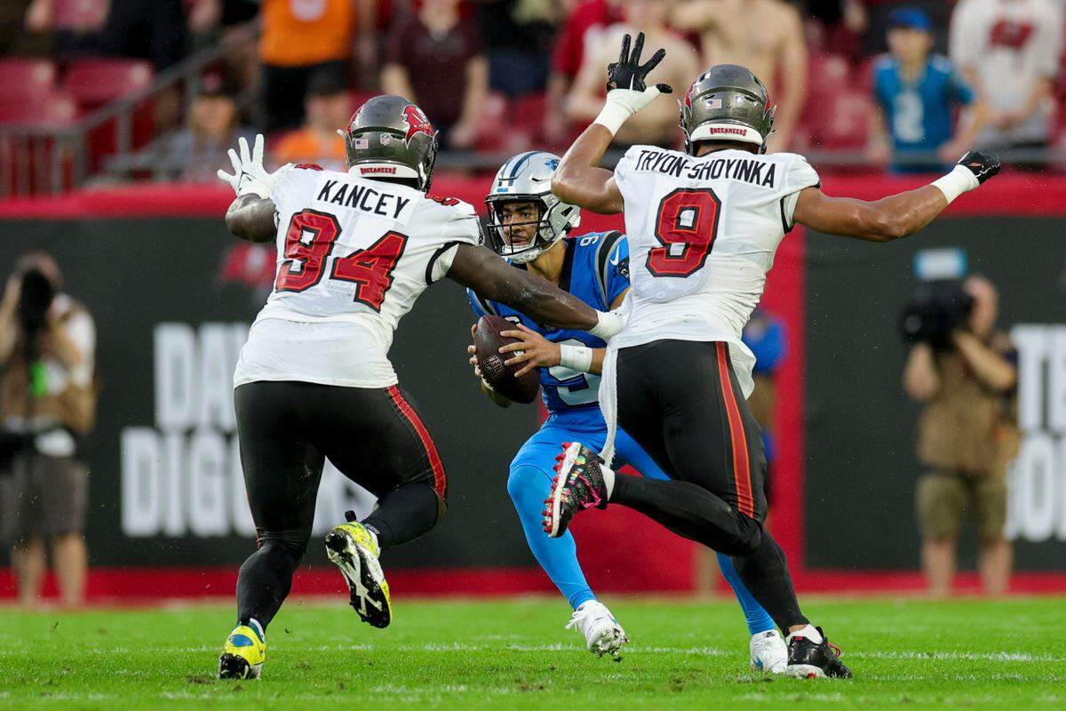 Dec 3, 2023; Tampa, Florida, USA; Tampa Bay Buccaneers defensive tackle Calijah Kancey (94) and linebacker Joe Tryon-Shoyinka (9) pressure Carolina Panthers quarterback Bryce Young (9) in the second quarter at Raymond James Stadium. Mandatory Credit: Nathan Ray Seebeck-USA TODAY Sports