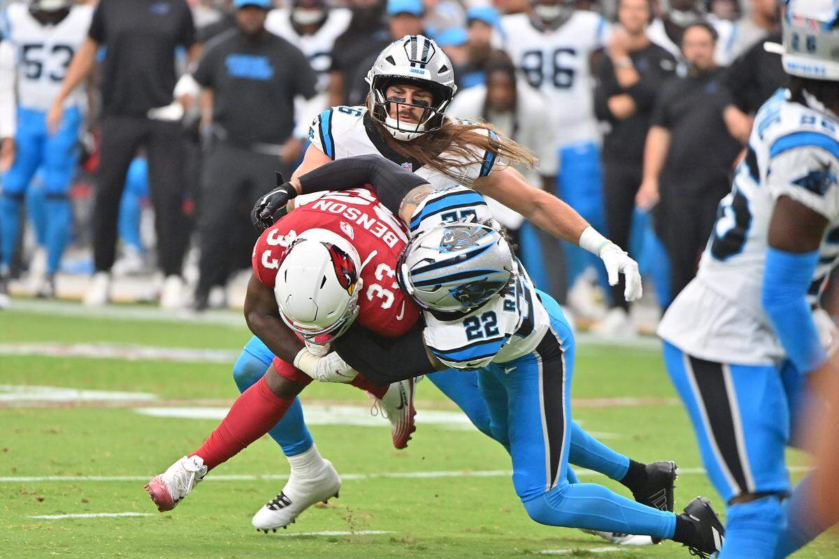 Arizona Cardinals running back Trey Benson (33) is tackled by Carolina Panthers safety Lathan Ransom (22) during the first quarter at State Farm Stadium in Glendale, Arizona on Sept. 14.