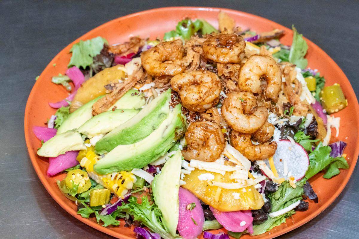 The Osito salad is a personalized choice of many toppings and a dressing and a choice of protein is optional.