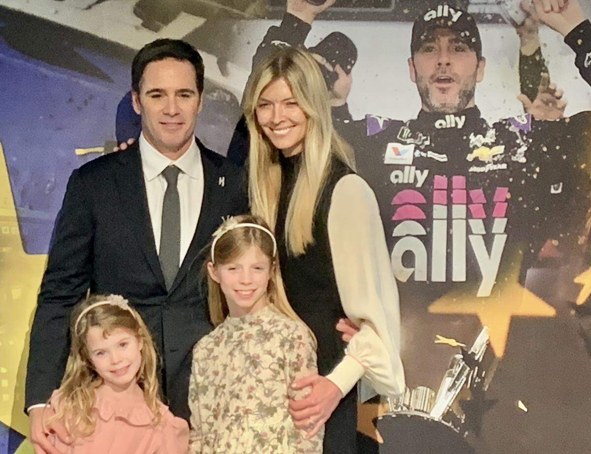 NASCAR driver Jimmie Johnson is surrounded by the rest of his family -- wife Chandra and daughters Lydia (left) and Genevieve -- after he announced his retirement from full-time racing following the 2020 season at a press conference on Nov. 21, 2019.