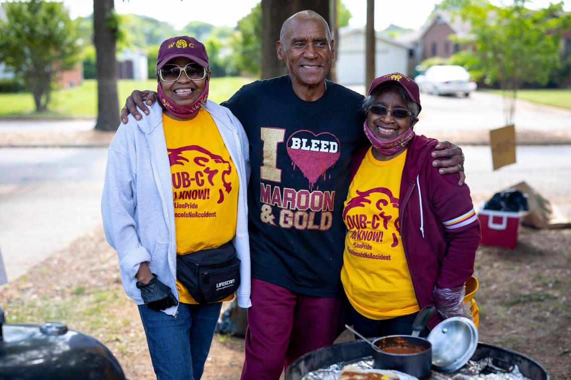 Eddie Ann Coulbreth, Fredrick Smith, and Mary Cathryn Wilson smile for a photo as the cook hot dogs and celebrate West Charlotte High School in Charlotte, NC on Saturday, April 30, 2022. The school hosted Lion Pride Day to invite all the alumni to come out and see the historic school before it will be demolished this summer. West Charlotte has a new school build adjacent to the original buildings and will be open this upcoming school year.