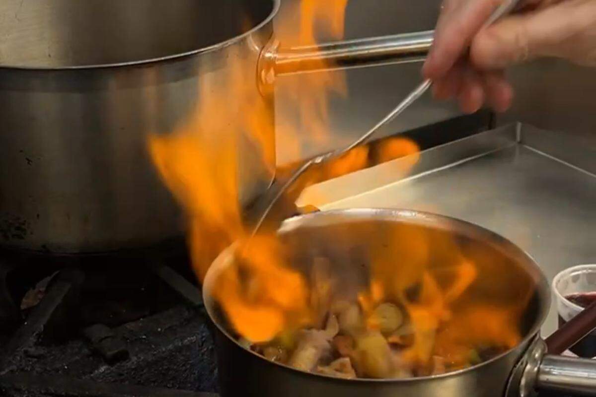 Once the wine is mostly reduced, chef Sam Diminich adds beef stock to reduce. Afterward, all of the vegetables should be cooked through, he said.