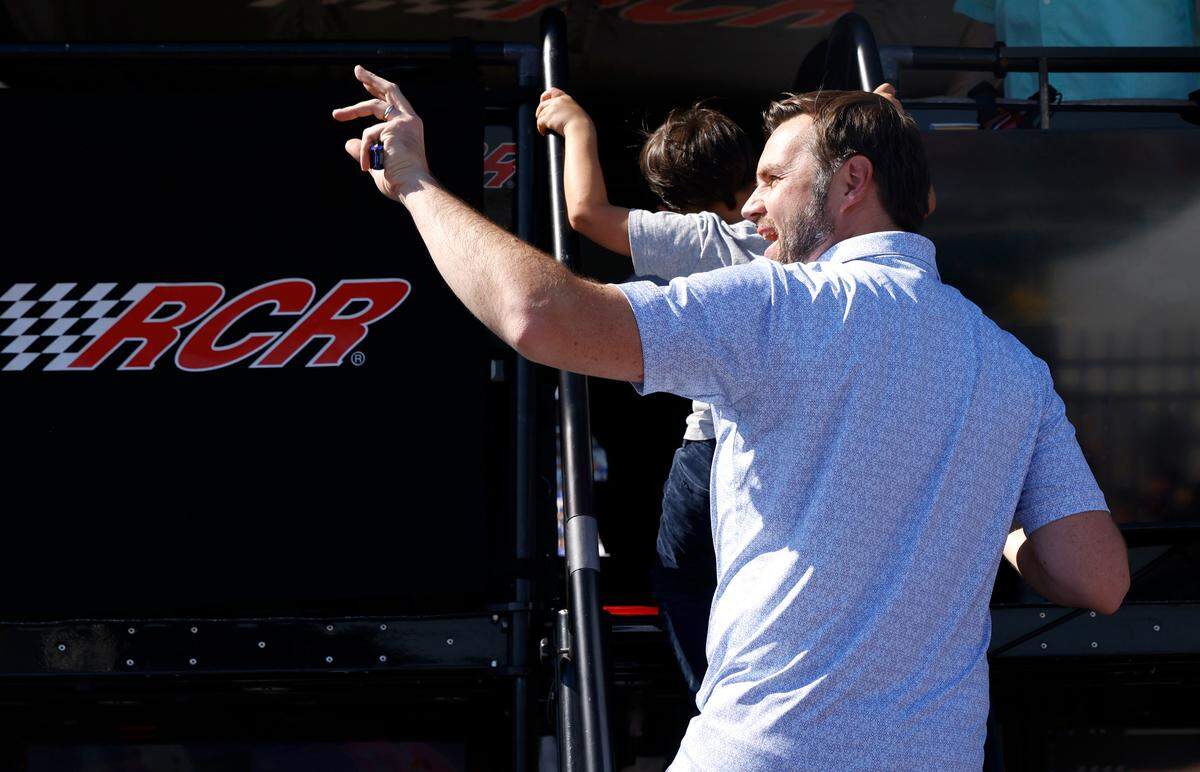 Vice Presidential Nominee Senator JD Vance waves to cheering NASCAR fans as he climbs onto a pit box to watch the running of the Bank of America Roval 400 at Charlotte Motor Speedway in Concord, NC on Sunday, October 13, 2024.