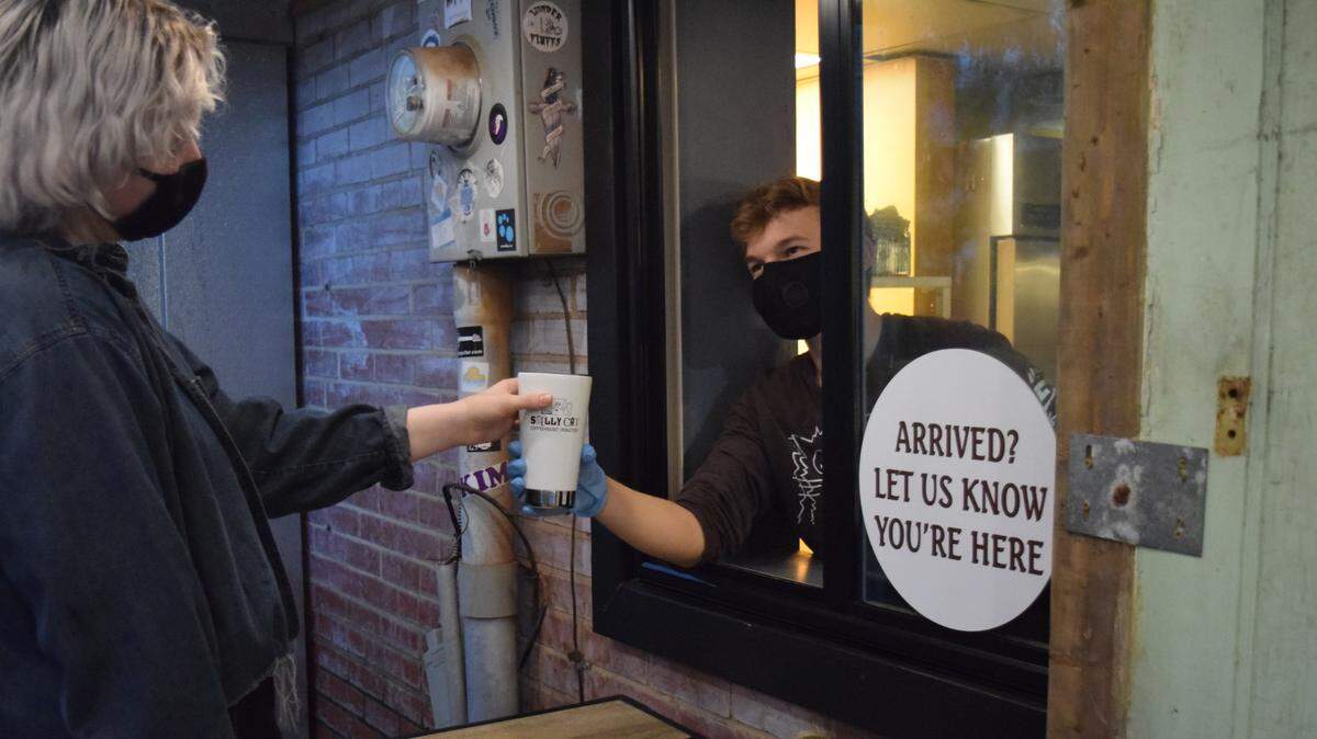 Smelly Cat Coffeehouse & Roastery manager Taylor Russell said her staff — including her brother R..J. Russell, shown here — has tried to find creative ways to make connections with customers during the COVID-19 pandemic.