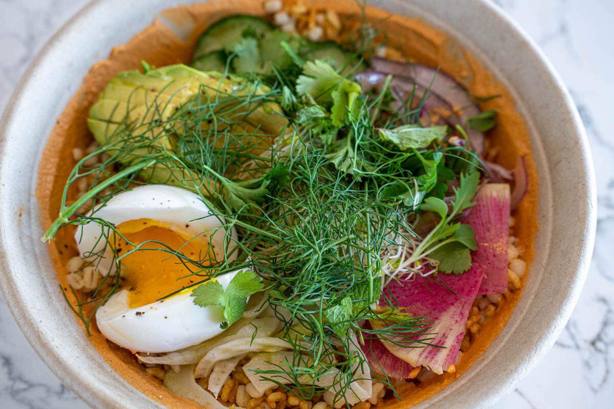 Milkbread’s Grain Bowl has crispy rice, jammy egg, almond romesco, avocado and sprouts.