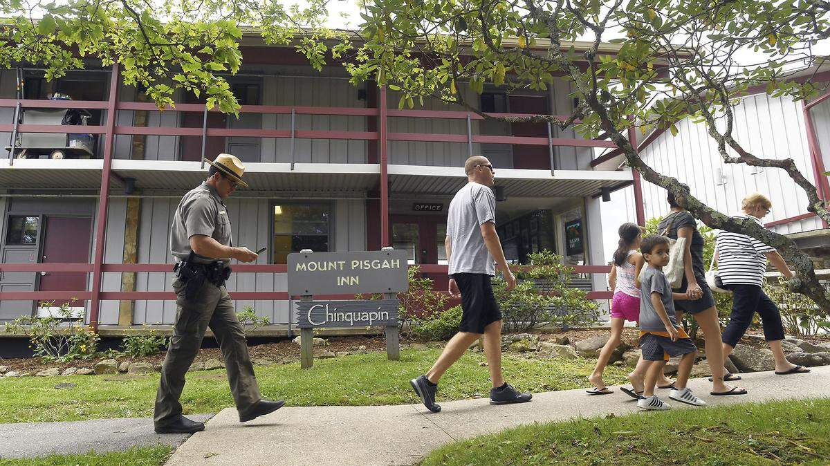 Law enforcement members remain at the Pisgah Inn after a body was found on a hiking trail, Thursday, July 26, 2018 near Brevard, N.C. Sara Ellis, a female cook who went missing at a scenic North Carolina inn was killed by a co-worker during a hike and left along a path near the famed Blue Ridge Parkway, federal authorities said Thursday. (Angela Wilhelm/The Asheville Citizen-Times via AP)