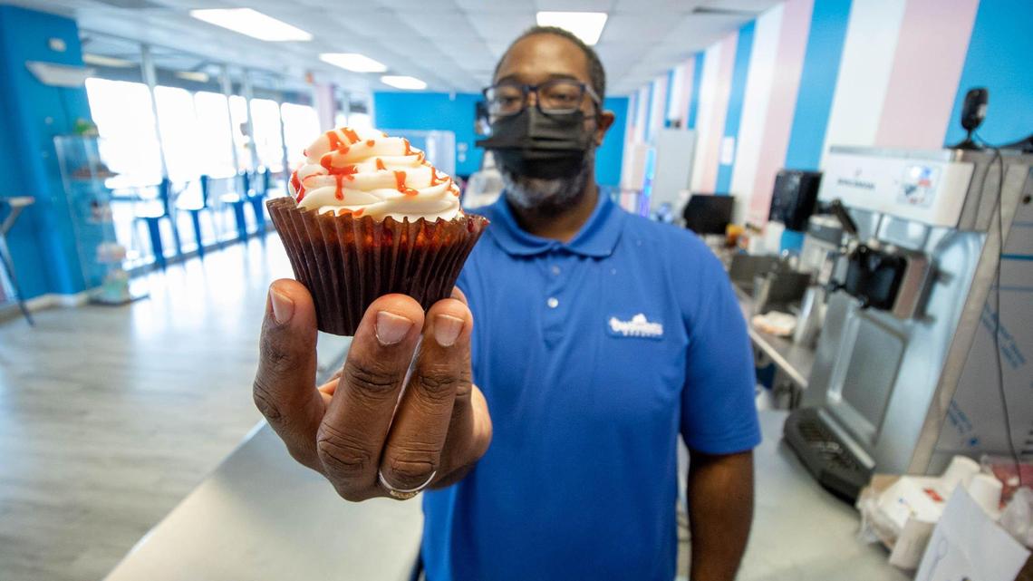 Frankie White of BW Sweets Bakery, holds a strawberry cupcake in Feb. 2021.
