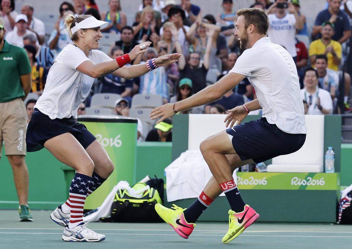 Bethanie Mattek-Sands, of the United States, left, runs into the arms of partner Jack Sock, after winning their mixed doubles gold medal match at the 2016 Summer Olympics in Rio de Janeiro, Brazil.