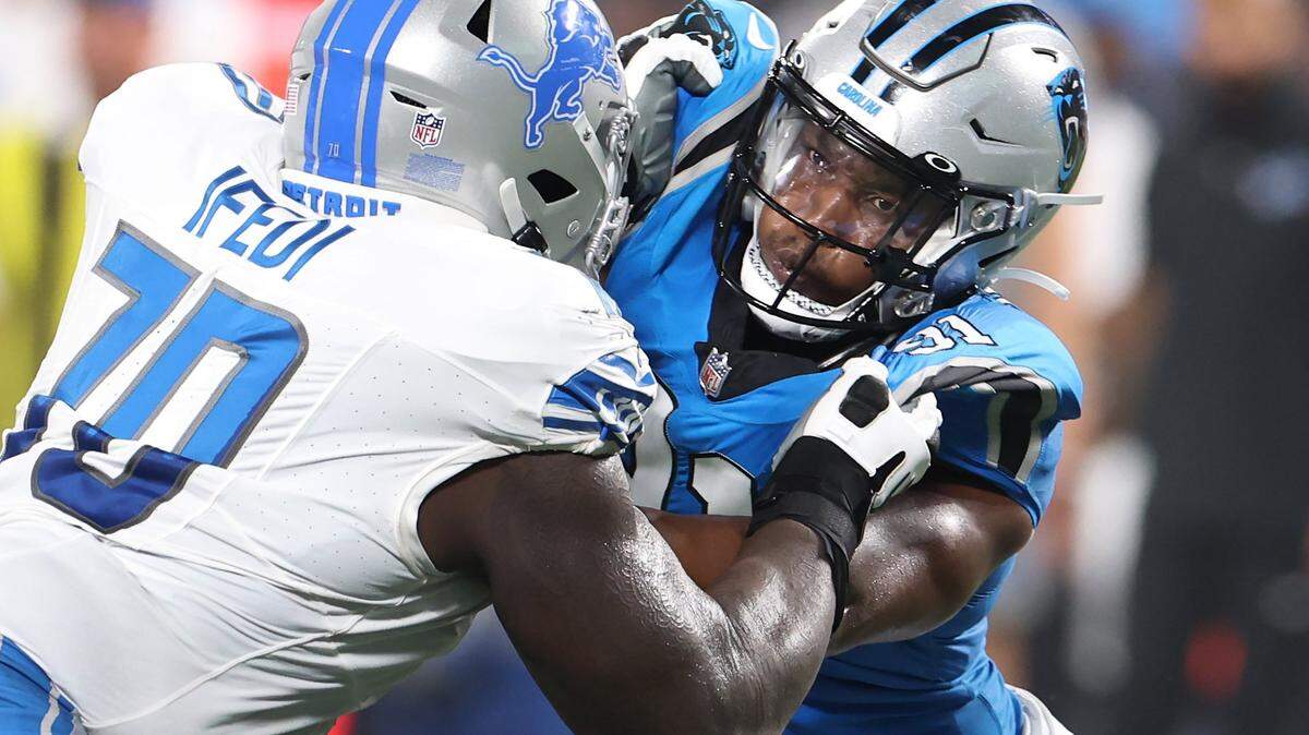 Carolina Panthers defensive end Kobe Jones, right, battles Detroit Lions tackle Germain Ifedi, left, during second quarter action on Friday, August 25, 2023 at Bank of America Stadium in Charlotte, NC.