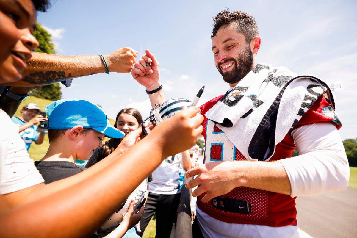 Carolina Panthers quarterback Baker Mayfield (6) signs autographs for fans after the teams training camp practice at Wofford College in Spartanburg, S.C., Thursday, July 28, 2022.
