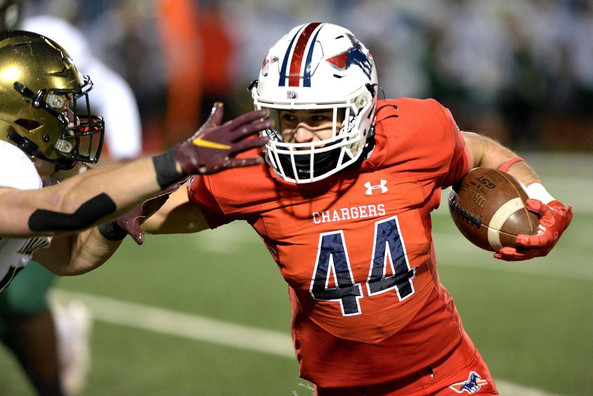 Providence Day Chargers running back Liam Grouix, right, pushes a Rabun Gap defender aside after intercepting a pass during first quarter action at Providence Day School in Charlotte, NC on Friday, November 19, 2021. The Chargers hosted Rabun Gap in the NCISAA boys state championship game.